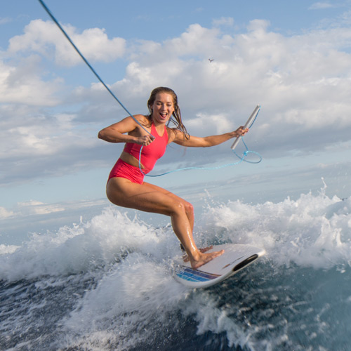 Woman wake boarding in warm waters in Islas Secas Panama